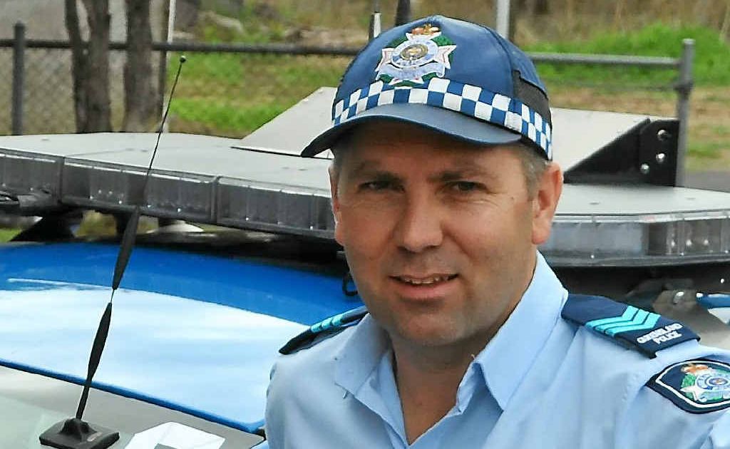 Sergeant Shane Reid with one of the white-ribbon clad police vehicles. Sergeant Shane Reid with one of the white-ribbon clad police vehicles.